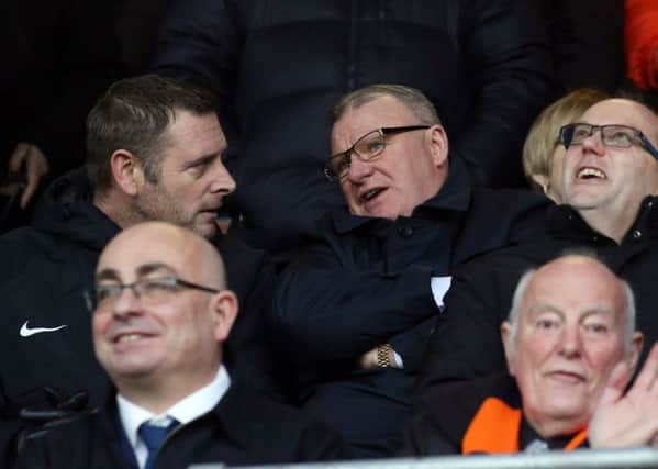 Posh chairman Darragh MacAnthony (left) with Steve Evans at Luton on January 19.