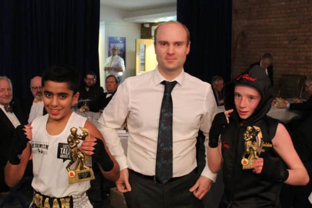 Imraan Shirazi (left) with opponent Charlie Harris and the bout sponsor.