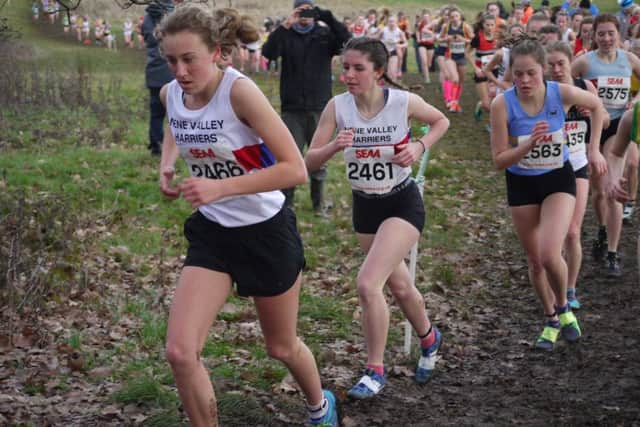 It's uphill for Harriers Katie Tasker and Hannah Knight.