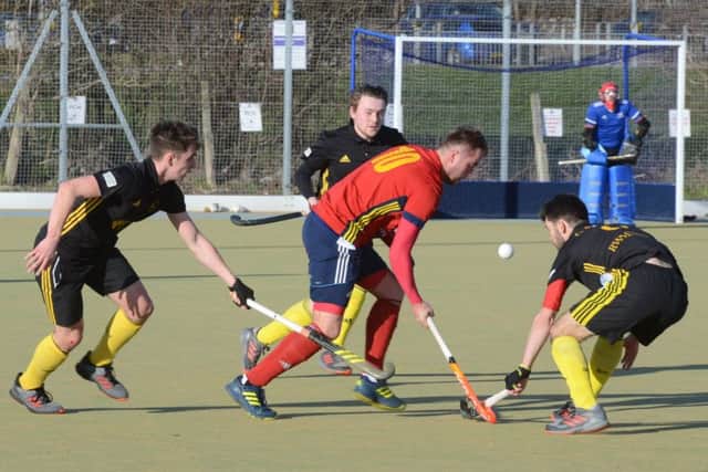 Cameron Heald (red) on the ball for City of Peterborough against Beeston. Photo: David Lowndes.