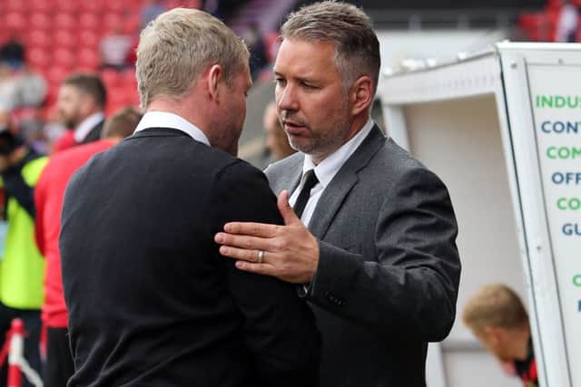 Darren Ferguson (right) and Grant McCann clash this weekend.