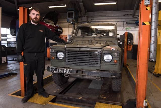 Adam Smith, Halfords Autocentre Manager and former soldier, services an army Land Rover as the retailer announces that it will be signing the Government's Armed Forces Covenant, at Halfords Autocentre in Peterborough.  Picture: Jeff Spicer/PA Wire