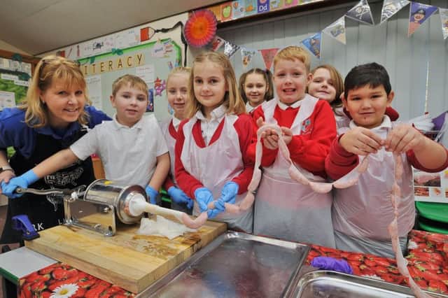 Pupils from Braybrook Primary Academy  taking part in the Kids Country breakfast week.  Pupils  making sausages with  Sandra Lauridsen, education manager for the East of England Agricultural Society EMN-190122-112210009