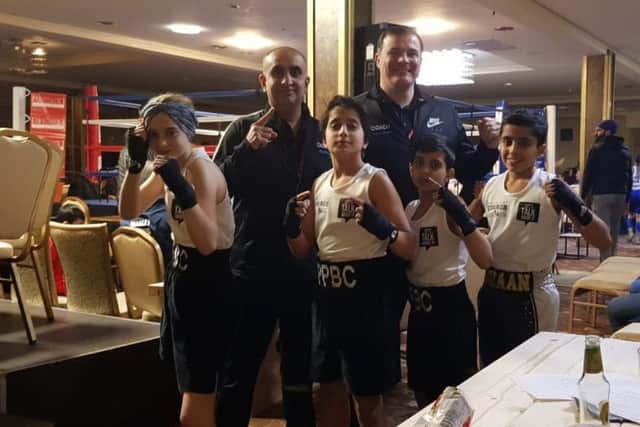 Pictured are Peterborough Police ABC coaches Akif Shirazi and Leighton Morgan with boxers Emily Anderson, Shahroz Raja, Rushaan Raja and Imraan Shirazi.