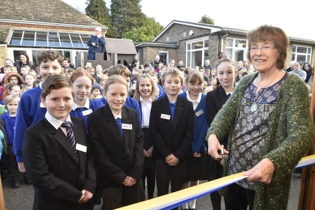 Christine Stevenson, wife of former headteacher at Castor C of E primary school, opening the new school bank and shop named in memory of her husband George Stevenson. EMN-191102-161728009