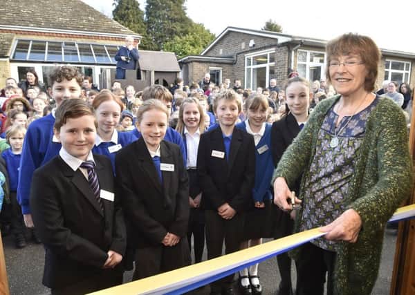 Christine Stevenson, wife of former headteacher at Castor C of E primary school, opening the new school bank and shop named in memory of her husband George Stevenson. EMN-191102-161728009
