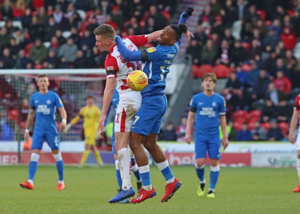 Ivan Toney of Peterborough United battles with James Morris of Doncaster Rovers. Picture: Joe Dent