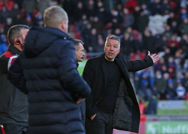 Posh boss Darren Ferguson appears not to be happy with Doncaster manager Grant McCann after the home side's controversial third goal. Photo: Joe Dent/theposh.com.