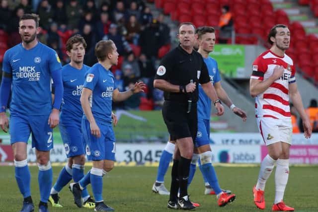 Struggling referee Carl Boyeson during the Posh defeat at Doncaster. Photo: Joe Dent/theposh.com.