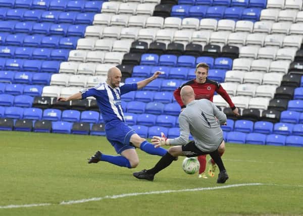 Moulton Harrox (blue) in action in last season's Senior Cup Final at the ABAX Stadium.