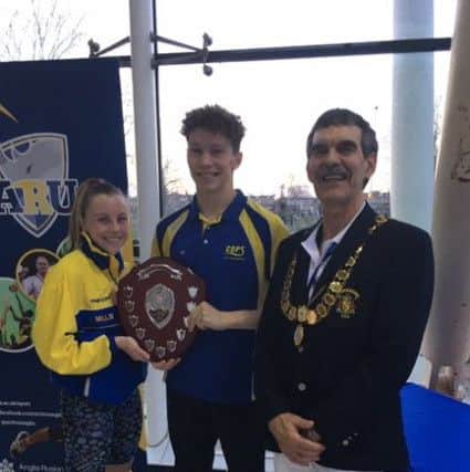 COPS swimmers Amelia Monaghan and Herbie Kinder receive the top club trophy.