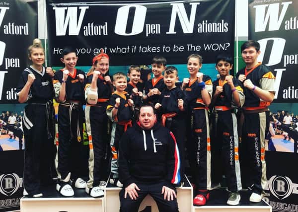 Andrew Hicks (front) with his team of fighters at the Watford Open. From the left are  Atlanta Hickman, Aaron Leonard, Lucy Hicks, Joshua Leonard, Oliver Profit, Denas Jankauskas, Tajus Jankauskas, Jolie Franks, Shiv Panchal and Aaron Dickerson.