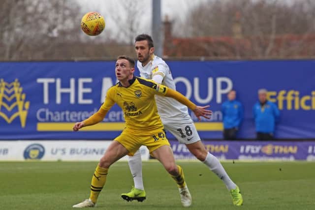Daniel Lafferty of Peterborough United in action with Gavin Whyte of Oxford United. Photo: Joe Dent/theposh/com.