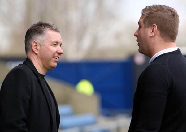 Posh boss Darren Ferguson (left) talks to Oxford manager Karl Robinson before the game. Photo: Joe Dent/theposh.com.