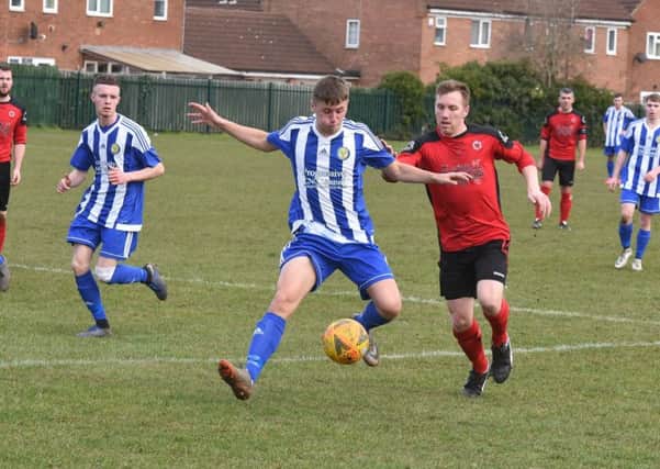 Ash Jackson (red), who was sent off, in action for Netherton against Peterborough Sports Development. Photo: David Lowndes.