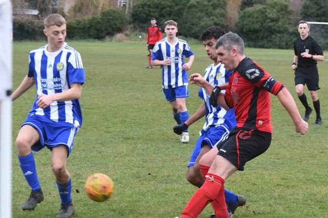 Mark Baines (red) in action for Netherton United at the weekend. Photo: David Lowndes.