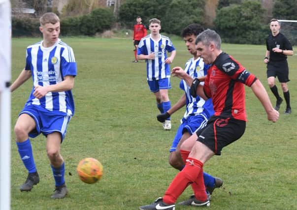 Mark Baines (red) in action for Netherton United at the weekend. Photo: David Lowndes.