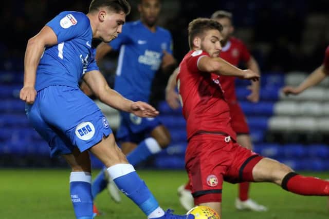 Mathew Stevens (blue) in action for Posh against Walsall in December.