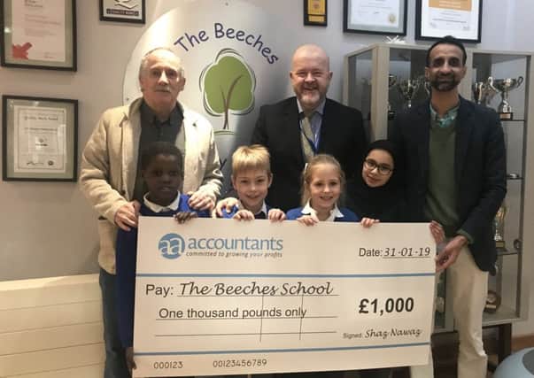 Labour Councillor Shaz Nawaz (right) donates £1,000 to The Beeches Primary School PHOTO: Supplied