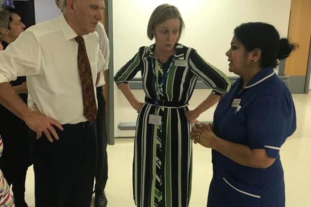 Vince and Caroline Walker speaking to senior staff nurse Jhancy Kannampalil, who was in charge on Ward A8 at the time. Photo: North West Anglia NHS Foundation Trust