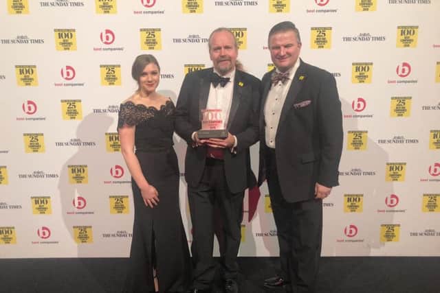 With the award, from left, Enya Lesiw, chairman Neil Russell, and Gavin Elsey.