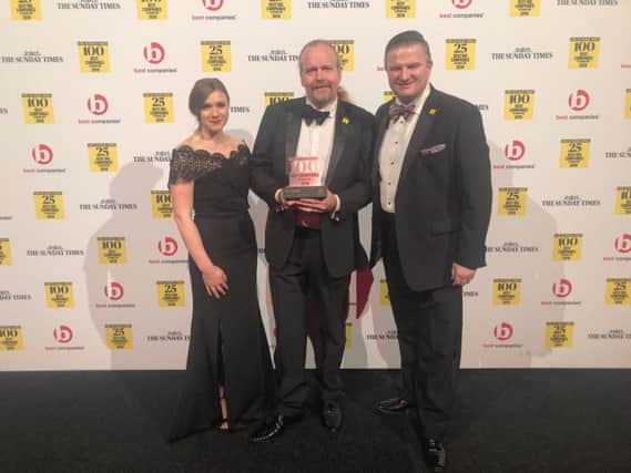 With the award, from left, Enya Lesiw, chairman Neil Russell, and Gavin Elsey.