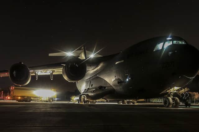 A Royal Air Force C-17 aircraft is refuelled