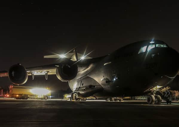 A Royal Air Force C-17 aircraft is refuelled
