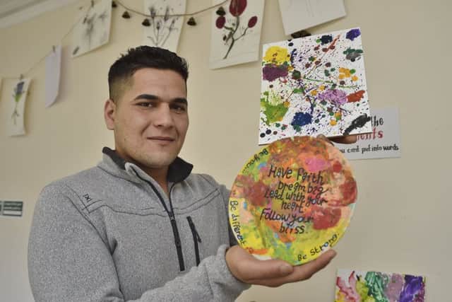 Shax Beker with some of the guests' artwork EMN-190226-133509009
