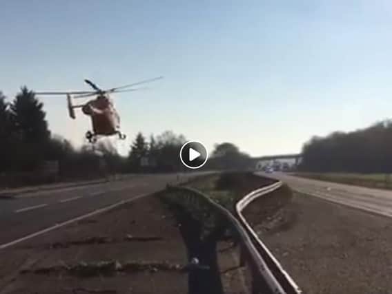 The Magpas air ambulance taking off from the A1 at Little Paxton
