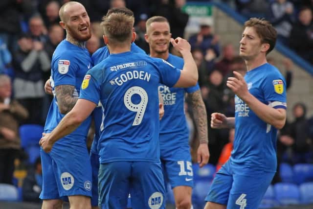 Marcus Maddison of Peterborough United celebrates scoring his second goal of the game with team-mates. Picture: Joe Dent