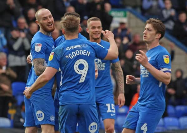 Marcus Maddison of Peterborough United celebrates scoring his second goal of the game with team-mates. Picture: Joe Dent