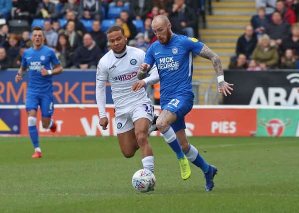 Marcus Maddison of Peterborough United in action with Curtis Thompson of Wycombe Wanderers. Picture: Joe Dent