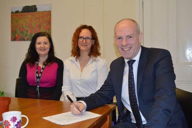 Angie Young (support worker for Peterborough Dawn Project), Stef Martinsen-Barker (CEO, Cambridge Women's Resource Centre) and minister Justin Tomlinson