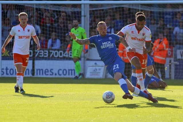 Marcus Maddison on the attack for Posh at home to Blackpool. The return fixture could be crucial.