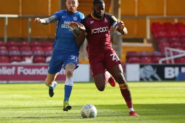 Marcus Maddison of Peterborough United in action with Hope Akpan of Bradford City. Picture: Joe Dent/theposh.com