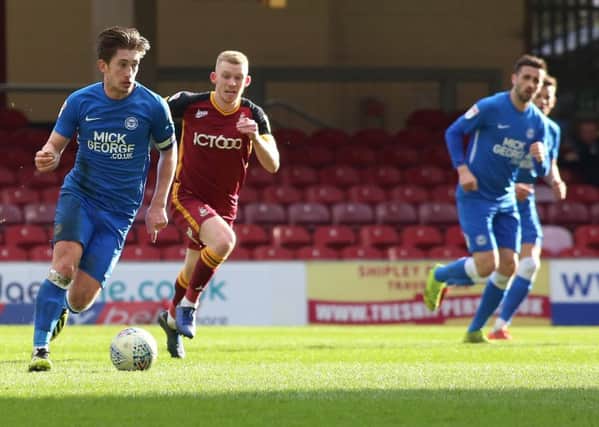 Alex Woodyard of Peterborough United in action with Lewis O'Brien of Bradford City. Picture: Joe Dent