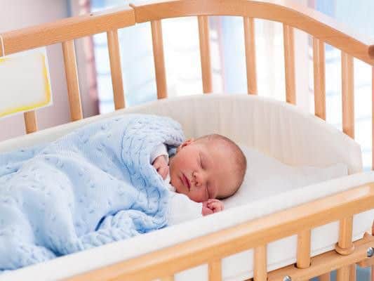 The safest place for a baby to sleep for the first six months is in a cot in the same room as its parents