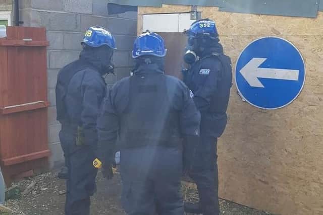 Specialist police entering one of the addresses in Peterborough