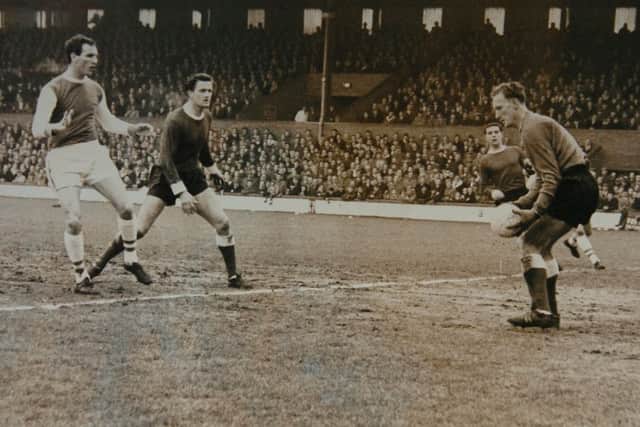 Derek Dougan (left) in action for Posh in 1964.