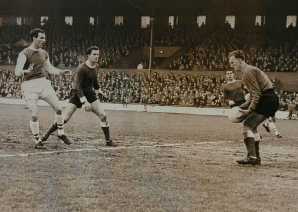 Derek Dougan (left) in action for Posh in 1964.