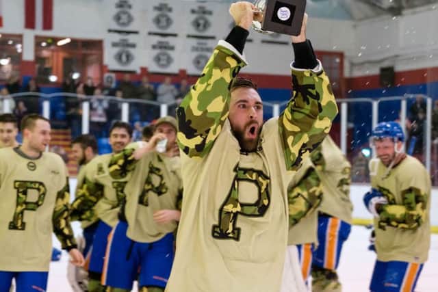 Phantoms captain James Ferrara holds aloft the NIHL South Cup. Picture: Tom Scott