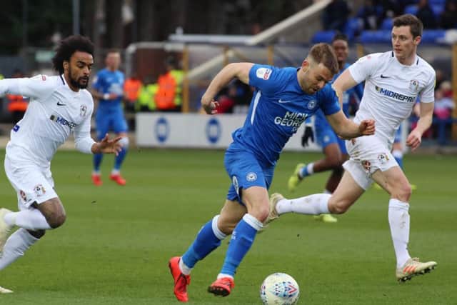 Matt Godden of Peterborough United gets away from Junior Brown and Dominic Hyam of Coventry City. Photo: Joe Dent/theposh.com.