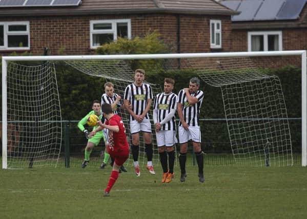 Action from Peterborough Northern Star (stripes) 0, Rothwell Corinthians 1. Photo: Tim Symonds.