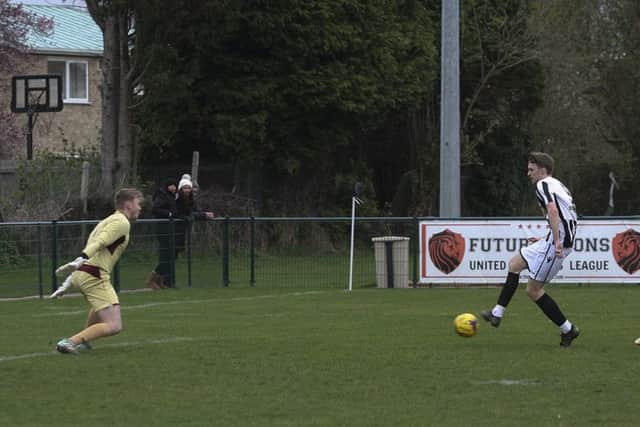 Action from Peterborough Northern Star (stripes) 0, Rothwell Corinthians 1. Photo: Tim Symonds.