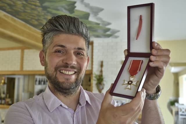 Eye restaurant owner Damian Wawrzyniak with his Knight's Cross medal.