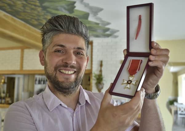 Eye restaurant owner Damian Wawrzyniak with his Knight's Cross medal.