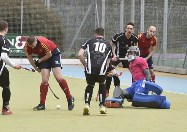 Action from City of Peterborough seconds (red) and Bourne Deeping firsts in the East Premier B Division. Photo: David Lowndes.