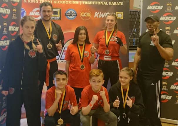 TASK fighters with chief instructor Rob Taylor. From the left are, back, Emilia SkupiDska, Richard Atkinson, Jazmyn Popat-Evans, Lucy Stirland, Rob Taylor, front, Taylor Popat-Evans, Braydon Popat-Evans and Skaiste Stukaite.