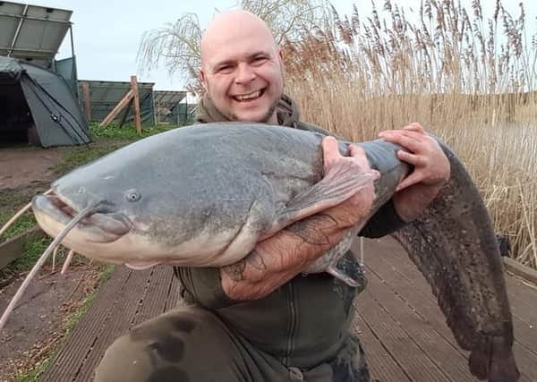 Trev Hoskins with his 64lb catfish.